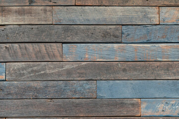 Weathered horizontal wooden boards with faded blue paint