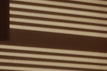 Shadows on an interior wall from venetian window blinds closeup
