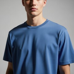Close-up portrait of a man wearing a bright blue t-shirt with a focus on fabric texture