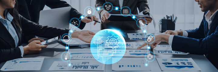 A diverse group of professionals actively collaborating in a modern office setting, analyzing charts and using digital tools to enhance project efficiency and drive results. Trope