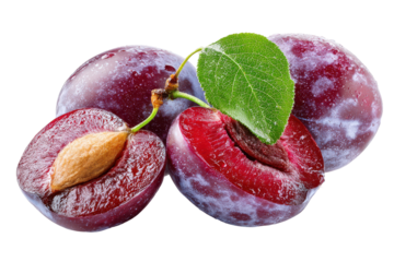 Fresh ripe plums with a leaf isolated on transparent background. Fresh ripe plums one cut open showing seed with green leaf isolated on white background.