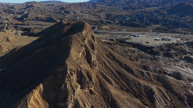 Majestic aerial view flying over the arid and eroded landscape of the Tabernas Desert in Almeria, Spain
