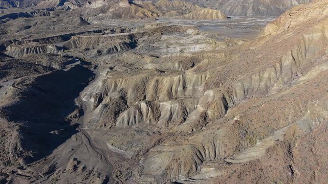 Drone flying over the eroded ravines and arid landscape of the Tabernas Desert in Almeria, Spain