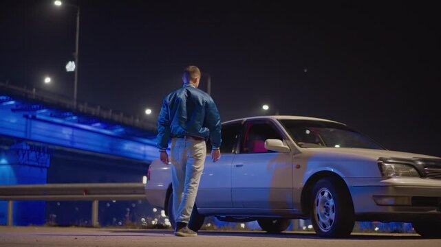 night underpass caucasian driver approaches car, solitary courier inspects coupe, street racer checks rearview, late shift mechanic opens door, tense rendezvous under blue neon bridge lights, asphalt