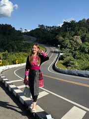 Elegant Woman in Traditional Hmong Dress Standing on the Scenic Number 3 Road in Nan, Thailand