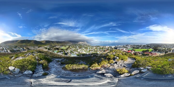 360 aerial photo taken with drone of Hoy's Koppie, a hill near downtown Hermanus with a view of mountains and sea on the Garden Route in South Africa