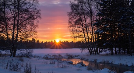 Winter landscape with snow covered trees and frozen lake at sunset