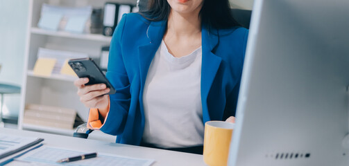 Asian business woman working on a laptop in a professional office
