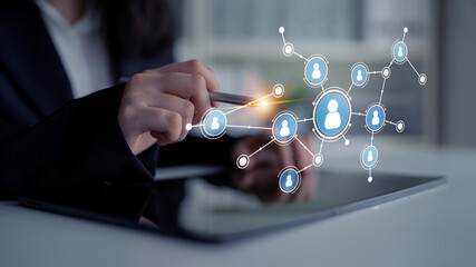 A business professional engages with a digital network on a tablet, showcasing the integration of technology in modern communication and collaboration strategies. Tessel