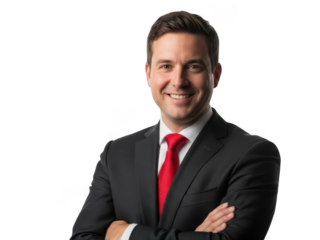 Confident smiling businessman in a dark suit and red tie with arms crossed, isolated studio portrait.