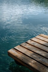 Fototapeta premium Tranquil lakeside wooden dock with rippling water reflections