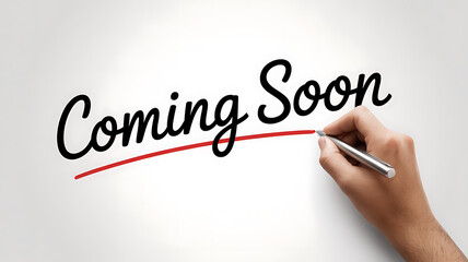 Hand writing Coming Soon message with a red line on a white background, announcement for new product or event launch.