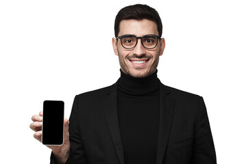 Smiling businessman showing blank phone screen for app presentation in black suit with glasses