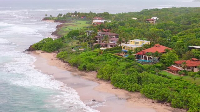 Aerial drone view of luxury beachfront villas along the coastline at Playa Negra in Guanacaste Costa Rica