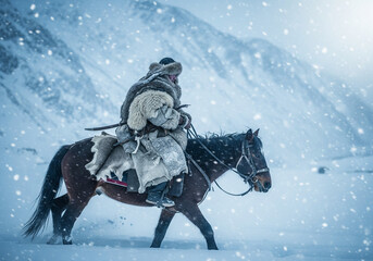 Nomad hunter in traditional fur clothing riding horse through heavy snow in high mountains