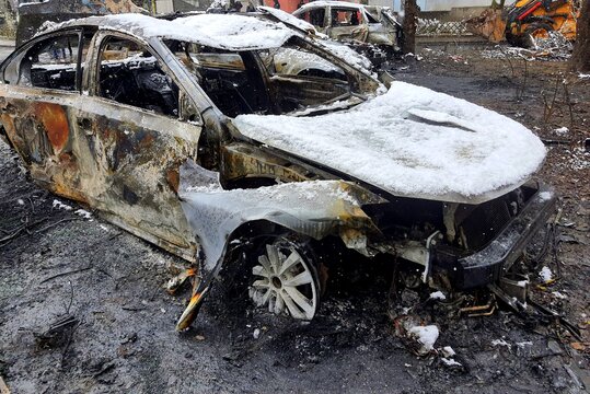 Burnt cars in parking lot, car interior burned. Russia s war against Ukraine, drone attack on Ukrainian city Dnipro, 2025, complete destruction of car, war risk insurance