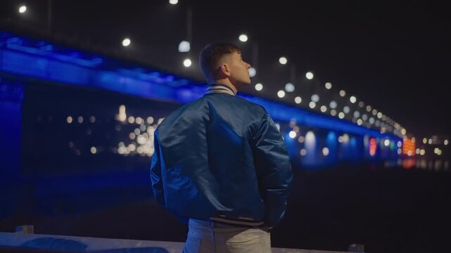 caucasian man gazing toward illuminated bridge, blue neon underpass and distant bokeh lights, quiet promenade at night, introspective posture, hopeful yearning, subtle lensflare, cinematic atmosphere