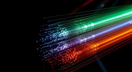 Closeup of vibrant fiber optic cables illuminating with colorful light trails against a dark background