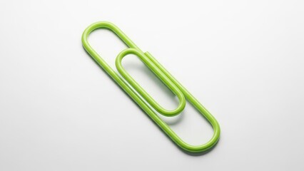 Obraz premium Green paperclip isolated on white background