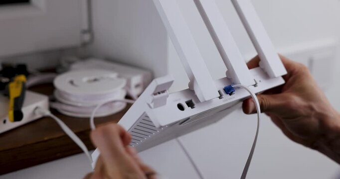 Wireless internet. Service provider technician plug in ethernet cables in Wi-Fi router. Network connection