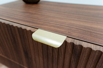 Closeup View Of Sophisticated Walnut Furniture Featuring Brass Fittings, Detailed Shot Of Luxurious Walnut Wardrobe Accentuated With Textured Brass Hardware And Fluted Woodgrain © Aleksey