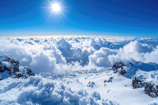 white clouds over the snowy mountain tops
