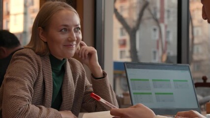 Focused woman student working on laptop during educational seminar,