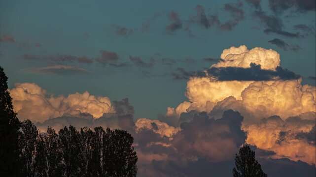 breve timelapse di grandi nuvole temporalesche in evoluzione all'orizzonte, colorate di arancione dal sole al tramonto