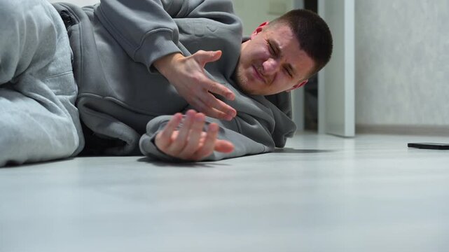 A person lies unconscious on the floor after suffering a head injury.
A person who feels unwell wakes up and gets up from the floor.
A person fell to the floor and hit his head.
Dizziness, pain, shock
