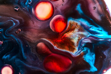 Vibrant abstract macro of liquid with intense red and blue color contrast, organic shapes, and dynamic flow. Ideal for creative backgrounds, digital art, posters, modern design projects.