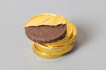 Pile of chocolate Euro coins isolated on gray background