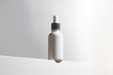 cosmetic medical skincare serum dropper bottle product mockup on white box in close-up view
