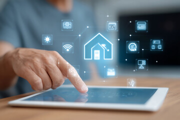 A person is pointing at a tablet with a house icon on it