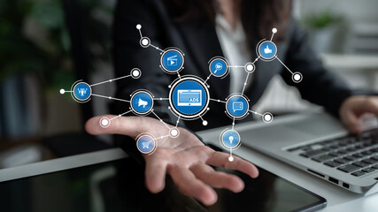 A business professional showcases digital marketing strategies through innovative technology in an office, emphasizing the importance of data connectivity and advertisements. Tessel