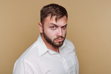 Obraz premium Man poses for a portrait with a serious expression against a plain background in a studio setting