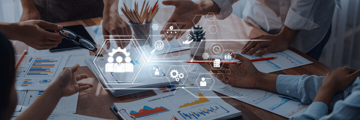 A vibrant business team collaborates on a project, showcasing a modern office setting. Digital interface graphics overlay discussions, enhancing teamwork and productivity. Trope