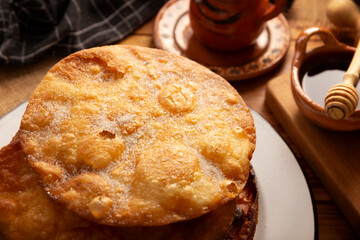 Bu&ntilde;uelos de rodilla. Traditional food at Christmas and winter holidays in Mexico, these are fried dough flour sprinkled with sugar or covered in a syrup made with piloncillo, cinnamon, and guava.