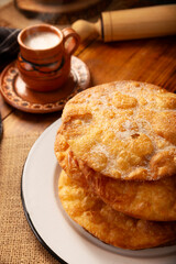 Bu&ntilde;uelos de rodilla. Traditional food at Christmas and winter holidays in Mexico, these are fried dough flour sprinkled with sugar or covered in a syrup made with piloncillo, cinnamon, and guava.