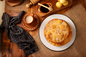 Bu&ntilde;uelos de rodilla. Traditional food at Christmas and winter holidays in Mexico, these are fried dough flour sprinkled with sugar or covered in a syrup made with piloncillo, cinnamon, and guava.