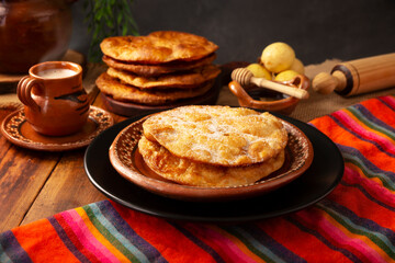 Bu&ntilde;uelos de rodilla. Traditional food at Christmas and winter holidays in Mexico, these are fried dough flour sprinkled with sugar or covered in a syrup made with piloncillo, cinnamon, and guava.