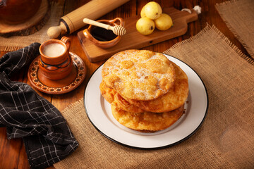 Bu&ntilde;uelos de rodilla. Traditional food at Christmas and winter holidays in Mexico, these are fried dough flour sprinkled with sugar or covered in a syrup made with piloncillo, cinnamon, and guava.