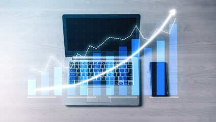 A modern laptop displaying a growth graph visualization alongside a smartphone on a wooden desk, representing business analytics and financial progress. Impute