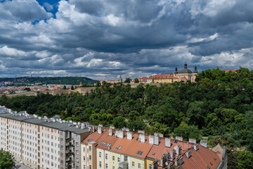 Breathtaking panoramic view of Prague, showcasing its historic city center with iconic buildings, charming red-roofed houses.