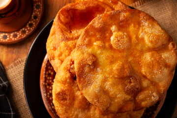 Bu&ntilde;uelos de rodilla. Traditional food at Christmas and winter holidays in Mexico, these are fried dough flour sprinkled with sugar or covered in a syrup made with piloncillo, cinnamon, and guava.