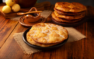 Bu&ntilde;uelos de rodilla. Traditional food at Christmas and winter holidays in Mexico, these are fried dough flour sprinkled with sugar or covered in a syrup made with piloncillo, cinnamon, and guava.