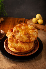 Bu&ntilde;uelos de rodilla. Traditional food at Christmas and winter holidays in Mexico, these are fried dough flour sprinkled with sugar or covered in a syrup made with piloncillo, cinnamon, and guava.