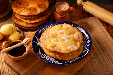 Bu&ntilde;uelos de rodilla. Traditional food at Christmas and winter holidays in Mexico, these are fried dough flour sprinkled with sugar or covered in a syrup made with piloncillo, cinnamon, and guava.