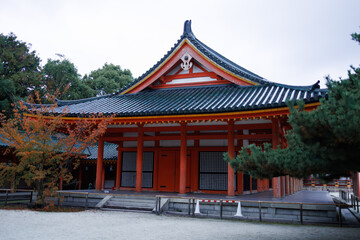 Traditional Red Japanese Temple Gate With Green Tiled Roof, Lanterns, And Wooden Details. Japan. Osaka Shimogamo Shrine