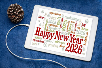Happy New Year 2026 greetings card  - word cloud on a digital tablet with a decorative frosty pine cone