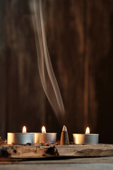 Candles and Incense Produce Smoke in a Simple Indoor Setting